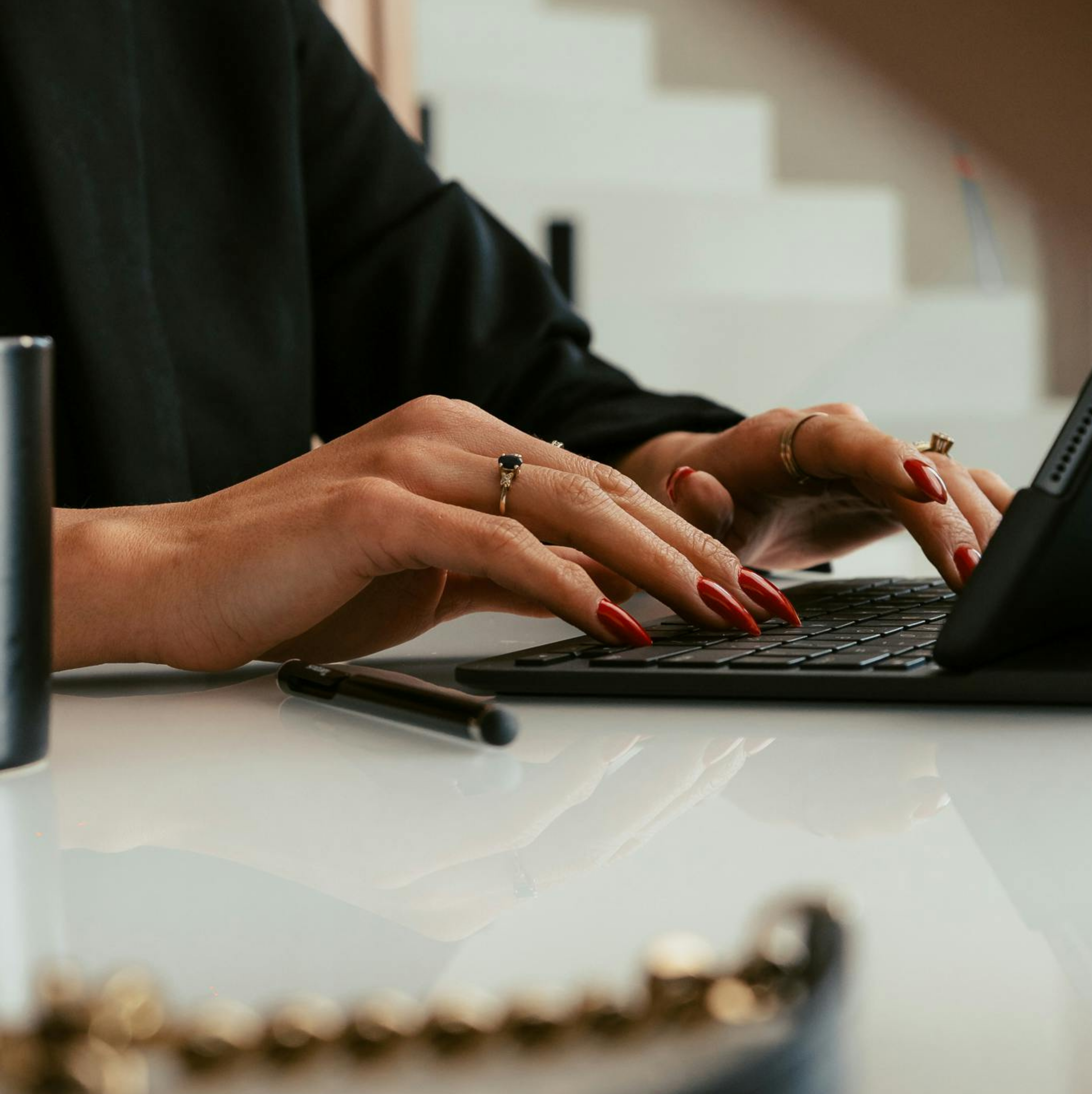 Divine by Design, neurodivergent business coach, typing at her desk